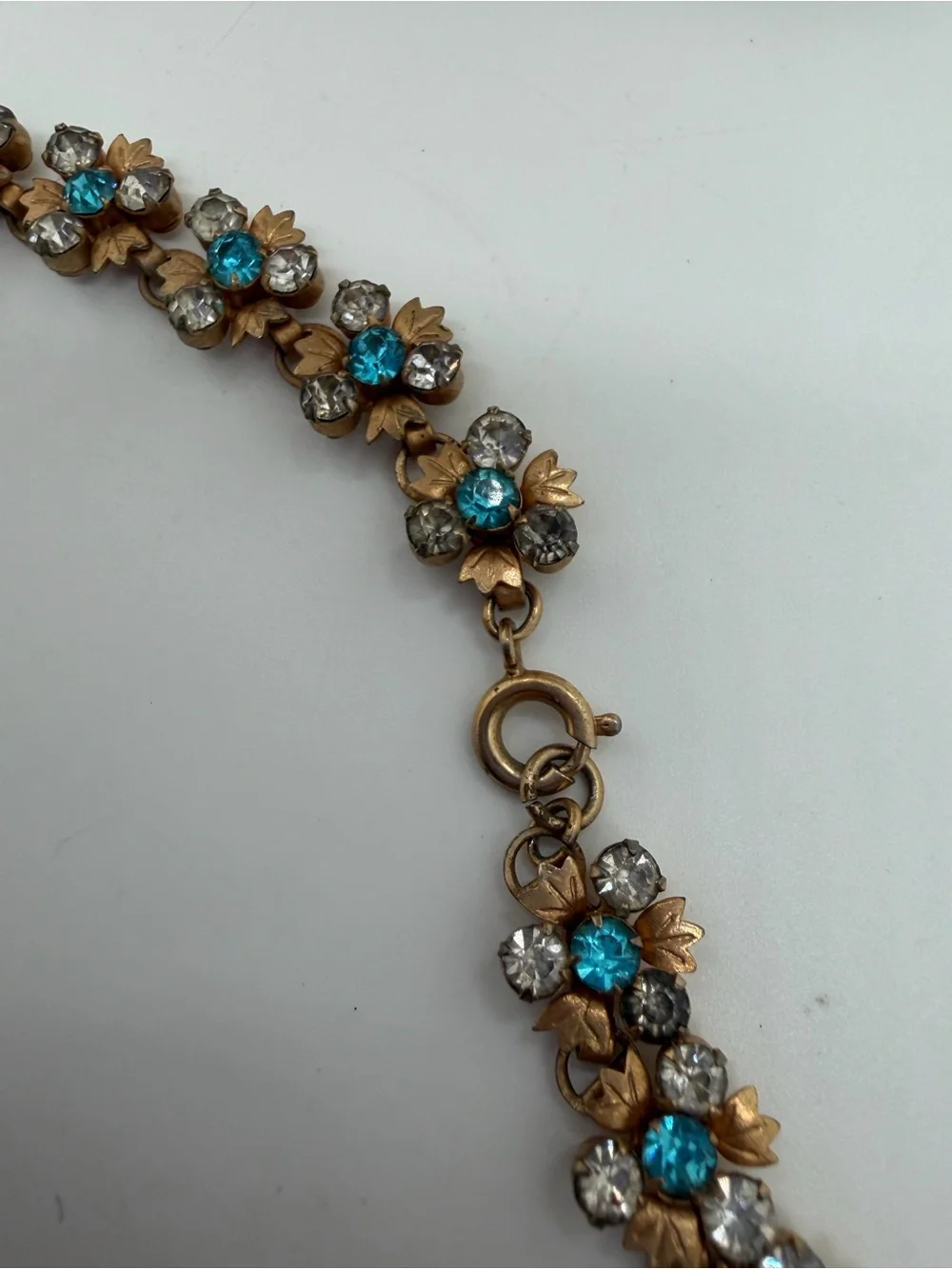 Vintage gold tone blue and clear rhinestone flower necklace